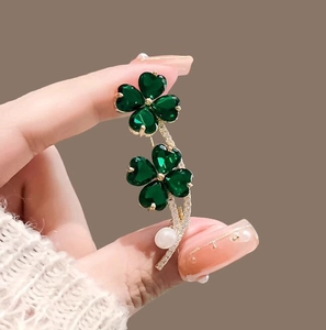 Elegant gold double clover brooch with green stones, pearl and zircon accents