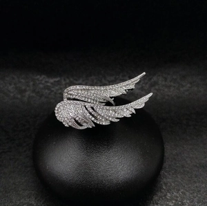 Detailed macro shot of silver wing ring featuring pavé-set sparkling cubic zirconia