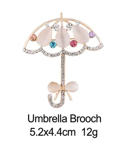 Élégante broche parapluie dorée avec pierres œil de chat et strass colorés 5,2x4,4cm