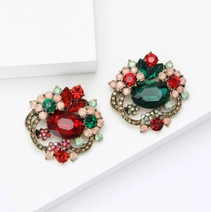 Elegant crystal flower brooch with red and green gemstones in vintage gold finish