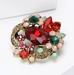 Vintage crystal flower brooch with red oval gemstone and rhinestones on bronze metal