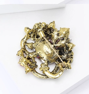 Detailed macro view of the alloy floral brooch back with secure pin clasp and rhinestones