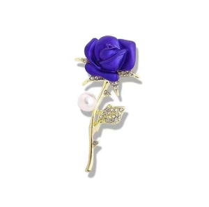 Detailed shot of purple frosted rose brooch with gold stem, crystals and pearl accent