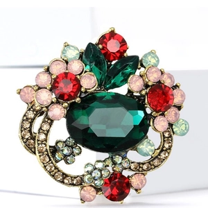 Elegant crystal flower brooch with large green gemstone and vintage gold floral setting