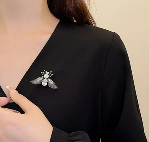 Exquisite bee brooch with teardrop crystal and translucent wings on black clothing