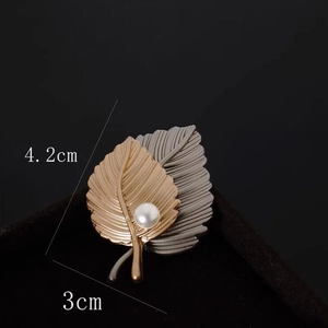 Elegant gold and grey maple leaf brooch with white pearl, sized 4.2cm by 3cm