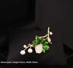 Detail of a Chinese lotus brooch with enamel leaves and pearls measuring 55mm by 39mm