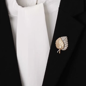 Elegant maple leaf brooch with pearls on black suit lapel for high-end fashion styling