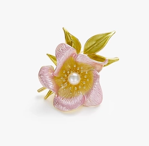 Detail of pink enamel camellia brooch with white pearl and golden leaf finish