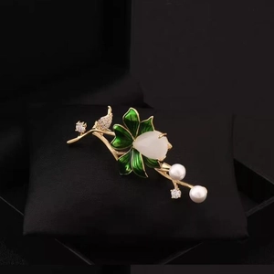 Exquisite gold lotus flower brooch with green enamel and white jade-style stones