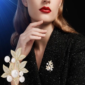 Luxurious golden leaf brooch with white pearls and zircons for elegant suit styling