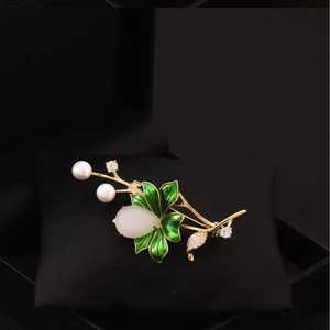 Elegant gold lotus brooch with green enamel leaves, white pearls and sparkling crystals