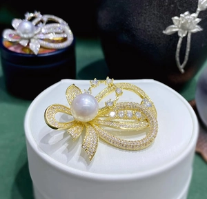 Detailansicht der Schleifen-Perlenbrosche mit glitzerndem Kristallpavé in Gold-Finish