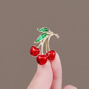 Exquisite red cherry brooch with gold base and green leaves for vintage sweater accessory