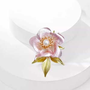 Elegant pink camellia flower brooch with pearl center and golden green leaves jewelry