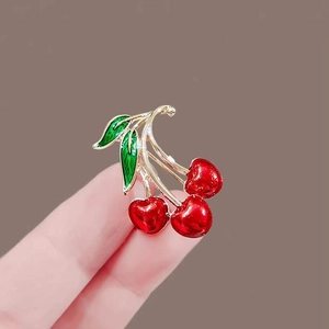 Exquisite red cherry brooch with gold stem and green leaves for elegant sweater accessory