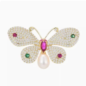 Elegant butterfly brooch with sparkling crystals, colorful gemstones and pearl drop