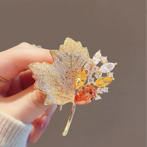 Vintage maple leaf brooch in gold with sparkling white and orange crystal rhinestones