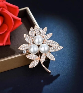 Elegant rose gold flower brooch with white pearls and sparkling leaf rhinestones