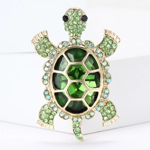 Exquisite gold-plated turtle brooch with green crystals and sparkling rhinestones