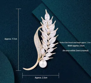 Elegant gold wheat ear brooch with sparkling marquise zircons and a white round pearl
