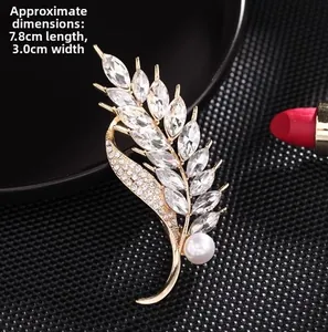 Detail shot of wheat ear pearl brooch measuring 7.8cm by 3.0cm with crystal accents