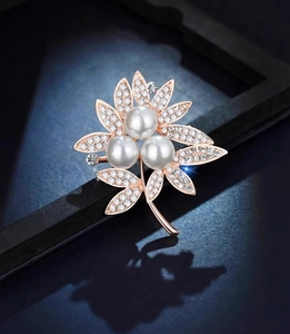 Elegant rose gold flower brooch with white faux pearls and sparkling crystals