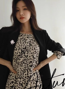 Detailed view of elegant silver flower brooch with pearls on a black suit lapel