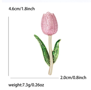 Detail view of tulip brooch dimensions 4.6cm by 2.0cm with pink crystals and green enamel