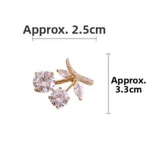 Detailed size measurement of a gold cherry brooch with white crystals, 2.5cm by 3.3cm