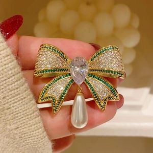 Elegant vintage gold bow brooch with green crystals and drop pearl for women