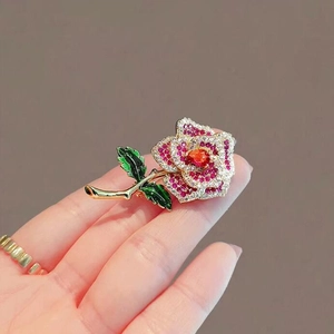 Exquisite gold rose brooch with sparkling colorful rhinestones and green enamel leaves