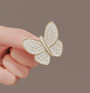 Macro shot of gold butterfly brooch with detailed clear cubic zirconia micro-pave setting