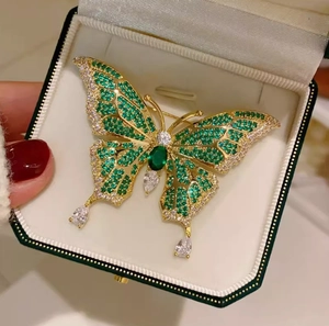 Vintage emerald butterfly brooch with gold plating and teardrop crystals in jewelry box
