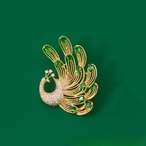 Macro shot of peacock brooch featuring emerald green crystals and gold metal finish