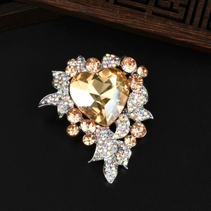 Luxurious champagne heart-shaped brooch with shimmering ribbon design and fine inlay