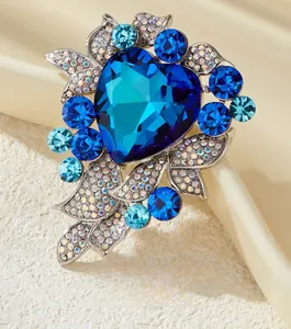 Close-up of luxury heart of the ocean brooch with blue crystals and silver wings