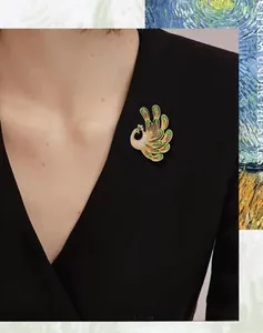 Detail of emerald green crystal peacock brooch pinned on a black professional suit blazer