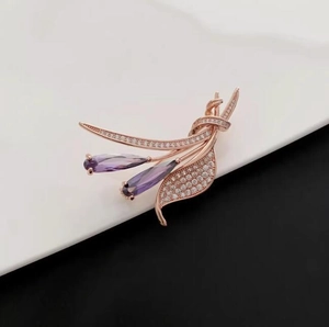 Détail de la broche fleur en or rose avec cristaux violets en poire et pavé de diamants