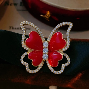 Elegant red butterfly brooch with gold plating and sparkling crystals for festive outfits
