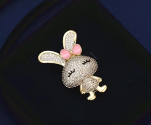 Détail d'une broche lapin mignonne avec zircons étincelants et petit nœud rose