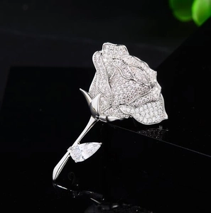 Macro shot of silver rose brooch featuring micro-pave zircons and pear-cut crystal detail