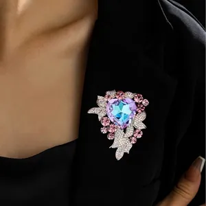 Luxury heart-shaped brooch featuring purple-blue crystal on a black suit lapel