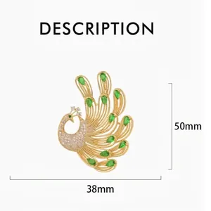 Elegant gold peacock brooch with emerald green crystals and white micro diamonds