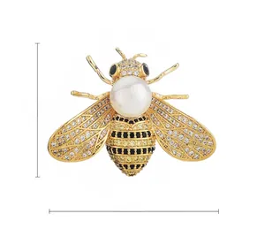 Detail view of a luxury bee brooch with white pearls and sparkling zircon stones
