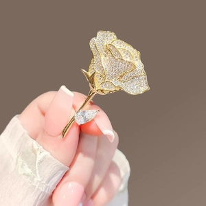 Exquisite gold-tone rose brooch with pavé set crystals and teardrop cubic zirconia stone