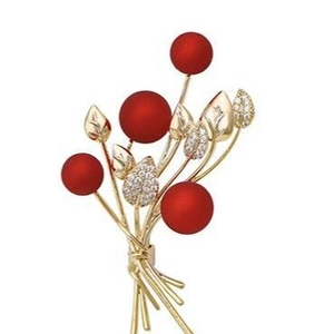 Elegant floral bouquet brooch with red matte berries and sparkling gold leaves