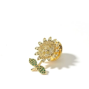 Detail showing the sunflower brooch with yellow zircons and green crystal leaves on white