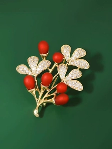 Elegant red berry ginkgo leaf brooch with crystals on a deep green background