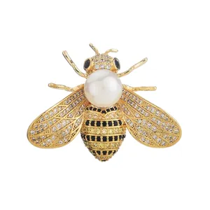 Elegant gold bee brooch with white pearl and yellow crystals measuring 36mm by 26mm